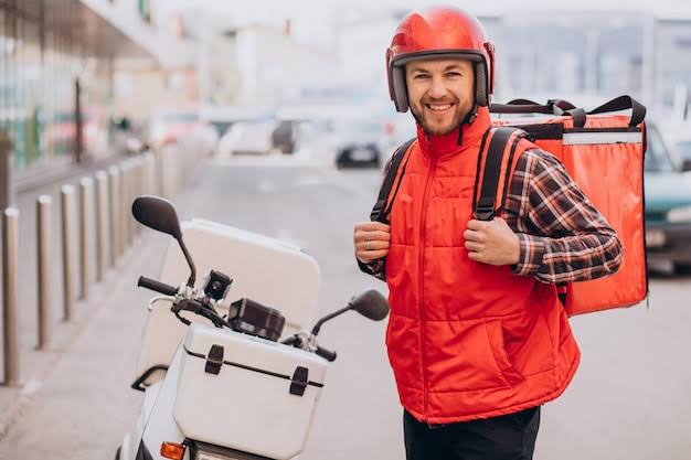 Motorcycle courier with red delivery bag
