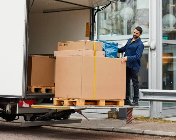 Warehouse worker loading packages into delivery truck